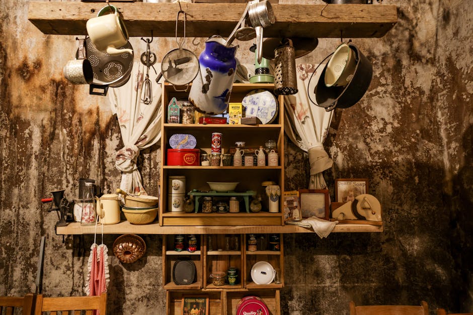 Cozy vintage kitchen interior with hanging utensils and rustic wooden shelves. Warm tones enhance the old-world charm.