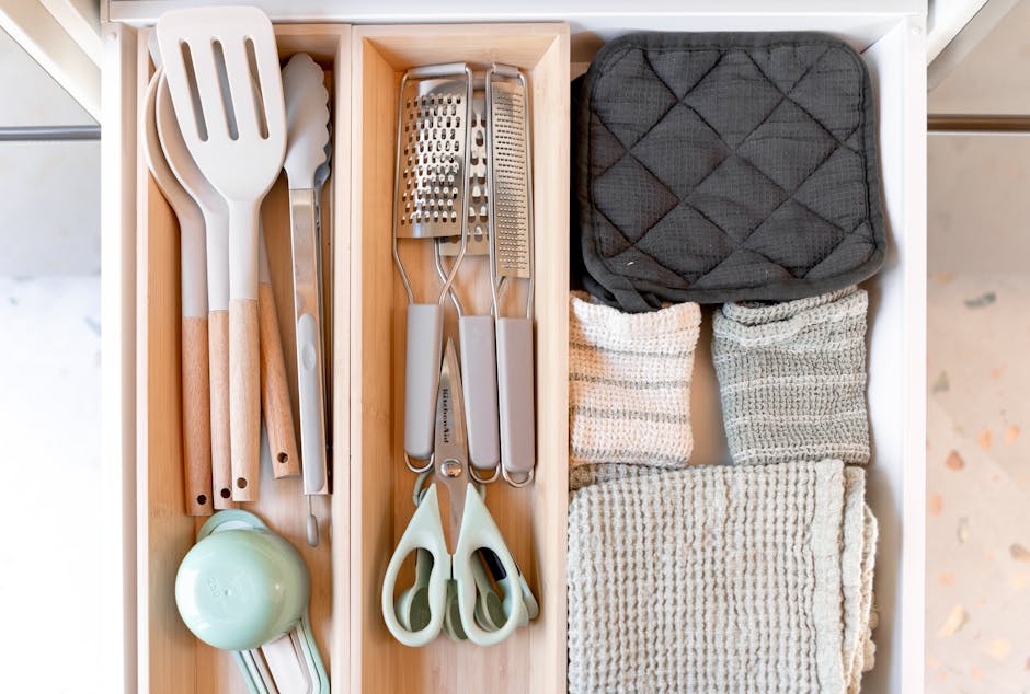 Neatly arranged kitchen tools and textiles in a drawer, showcasing an organized culinary space.